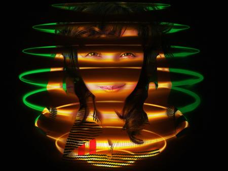 Girl dj with headphones enjoying in neon spiral rings