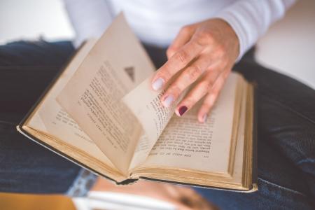 Girl thumbs through the old book