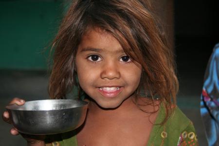 Girls on Green Shirt Holding a Silver Round Bowl