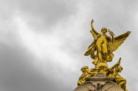 Gold Angel Statue Under Grey Clouds