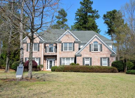 Gray and Brown House Behind Green Grass during Daytime