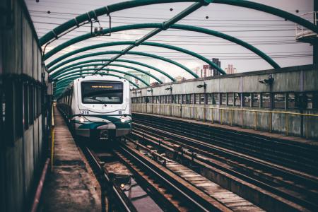 Gray and Green Train on Railings during Daytime