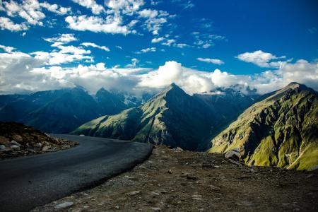 Gray Asphalt Road Near Green Fold Mountain at Daytime