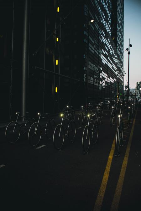 Gray Bike on Road Between Buildings