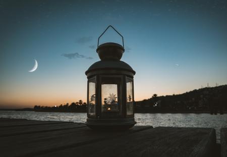 Gray Metal Candle Lantern on Boat Dock