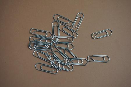 Gray Paper Clip on Brown Table