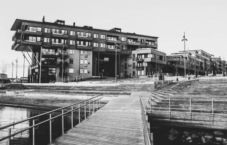 Gray Scale Photo of a Dock Near a Building