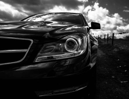 Gray Scale Photo of Car on Side of the Road