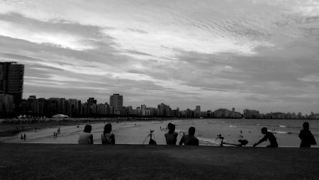 Gray Scale Photo of Group of People Near on Beach