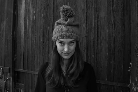 Gray Scale Photo of Woman Smiling in Front of the Camera