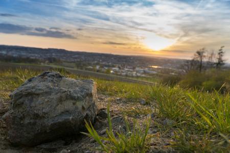 Gray Stone on Grassy Field during Under Cloudy Sky during Sunset