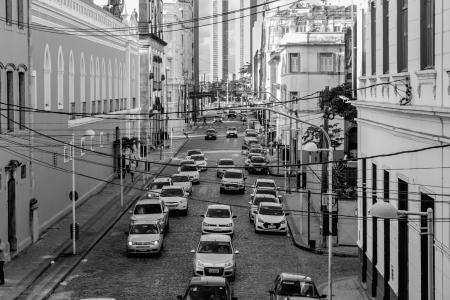 Grayscale Photo of Assorted Cars at the Middle of High Rise Buildings