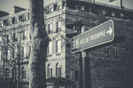 Grayscale Photo of Black and White Arc De Triomphe Street Sign