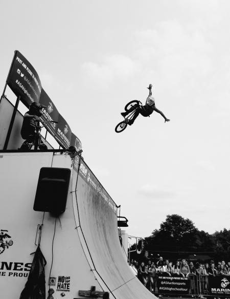 Grayscale Photo of Bmx Rider on Tournament