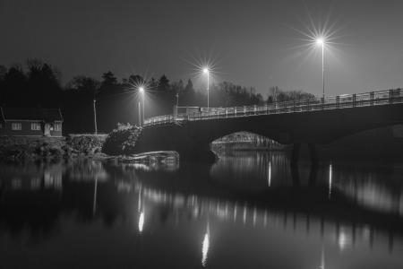 Grayscale Photo of Bridge at Night