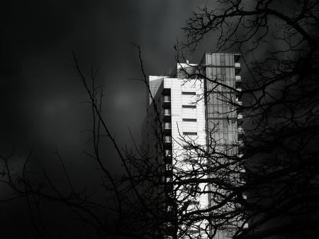 Grayscale Photo of Concrete High Rise Building