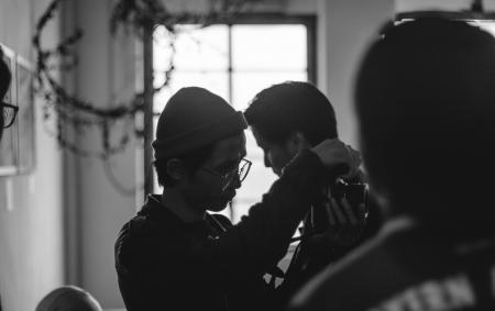 Grayscale Photo of Man Holding Man's Neck
