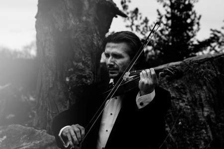 Grayscale Photo of Man Playing Violin