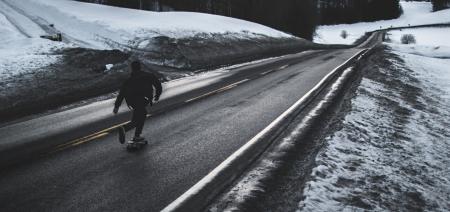 Grayscale Photo of Man Walking on Road