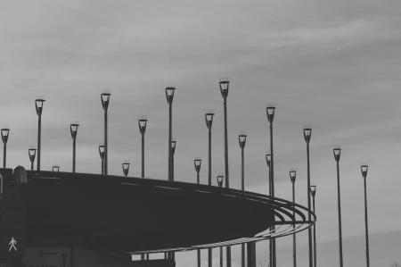 Grayscale Photo of Road Light Post Lot