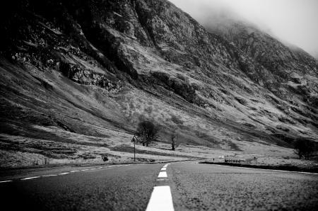 Grayscale Photo of Road Thru Mountain