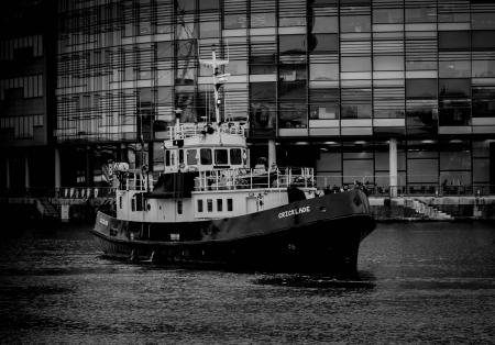 Grayscale Photo of Ship Near Building