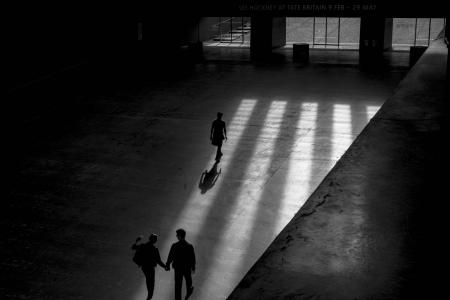 Grayscale Photo Of Three Men Walking Inside Building