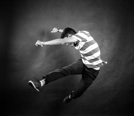 Grayscale Photograph of Man Wearing White and Black Stripe Crew Neck T Shirt