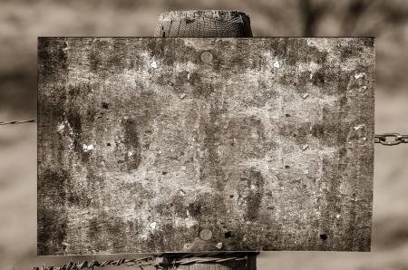 Grayscale Photography of Brown Wooden Board on Fence