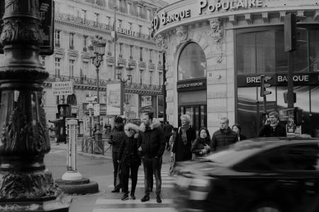 Grayscale Photography of Man Crossing Road