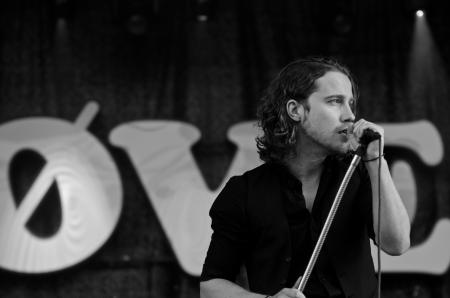 Grayscale Photography of Man Wearing Dress Shirt While Holding Microphone