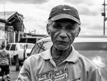 Grayscale Photography of Man Wearing Polo Shirt and Nike Cap