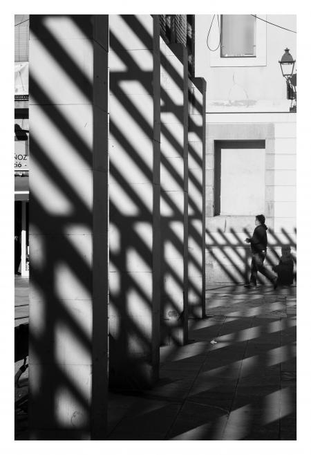 Grayscale Photography of Man Wearing Pullover Hoodie Near Gray Wall