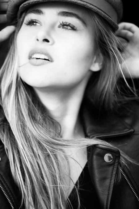 Grayscale Photography of Woman Wears Leather Jacket and Cap