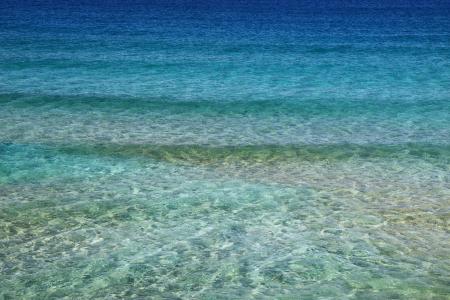 Green and Blue Body of Water Under Blue Sky