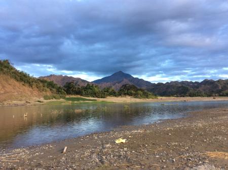 Green and White Mountains Near Body of Water