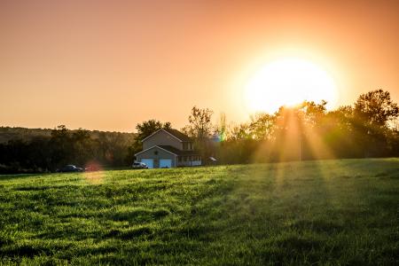 Green Field and Brown and White House during Sunrise