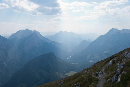 Green Grasses on Rocky Mountains Under Blue Sky