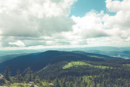 Green Hills Below White Cloudy Sky