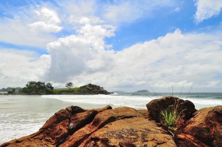 Green Island Under White Clouds and Blue Sky at Daytime