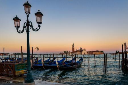 Green Metal Post in Front of the Body of Ocean With Boats during Twilight