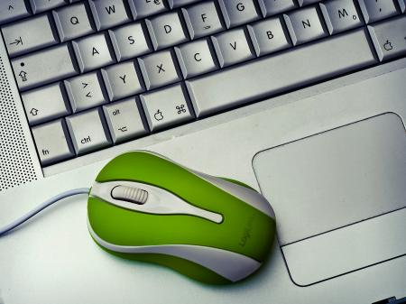 Green Mouse on silver Laptop