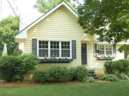 Green Red and Yellow Garden in Front of Gray Concrete House during Daytime