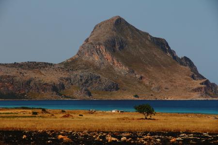 Grey and Brown Rock Formation Near Calm Water Photo