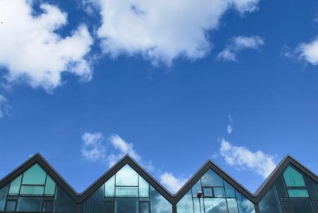 Grey Wood and Glass House Under Blue Sky and Clouds during Daytime