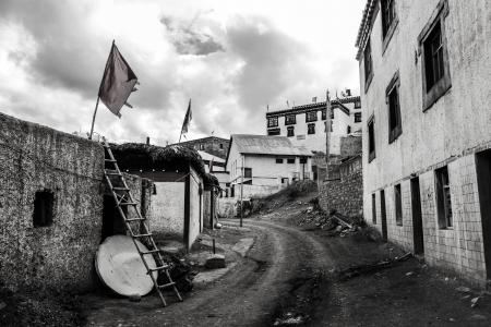 Greyscale Photo Dirt Road Between Buildings