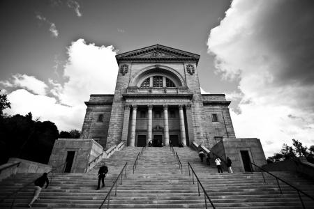 Greyscale Photo of a Building With Walking People