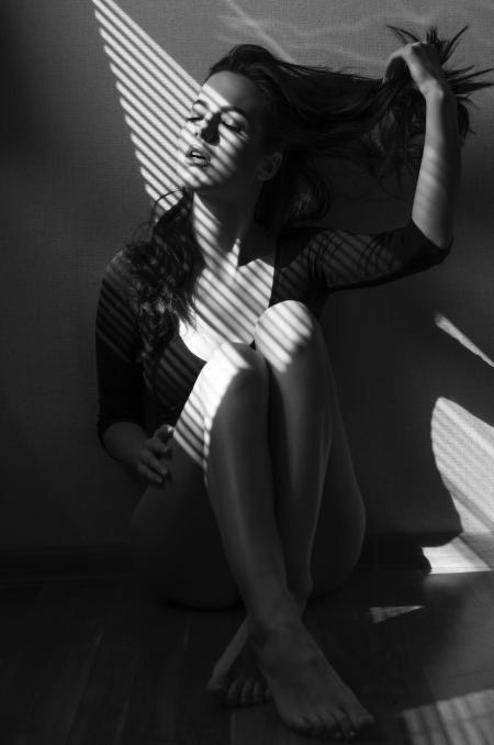 Greyscale Photo of Sitting Woman