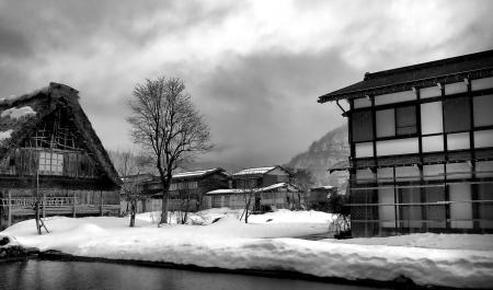 Greyscale Photo of Snow Field and House Painting