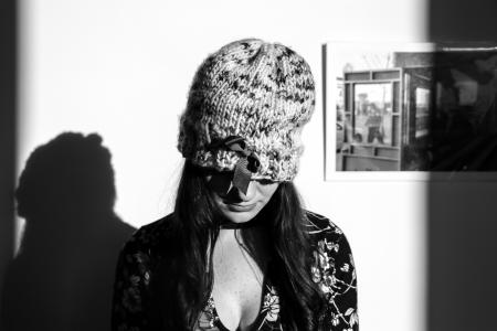 Greyscale Photo of Woman Wearing Knitted Hat and Floral Long-sleeved Top